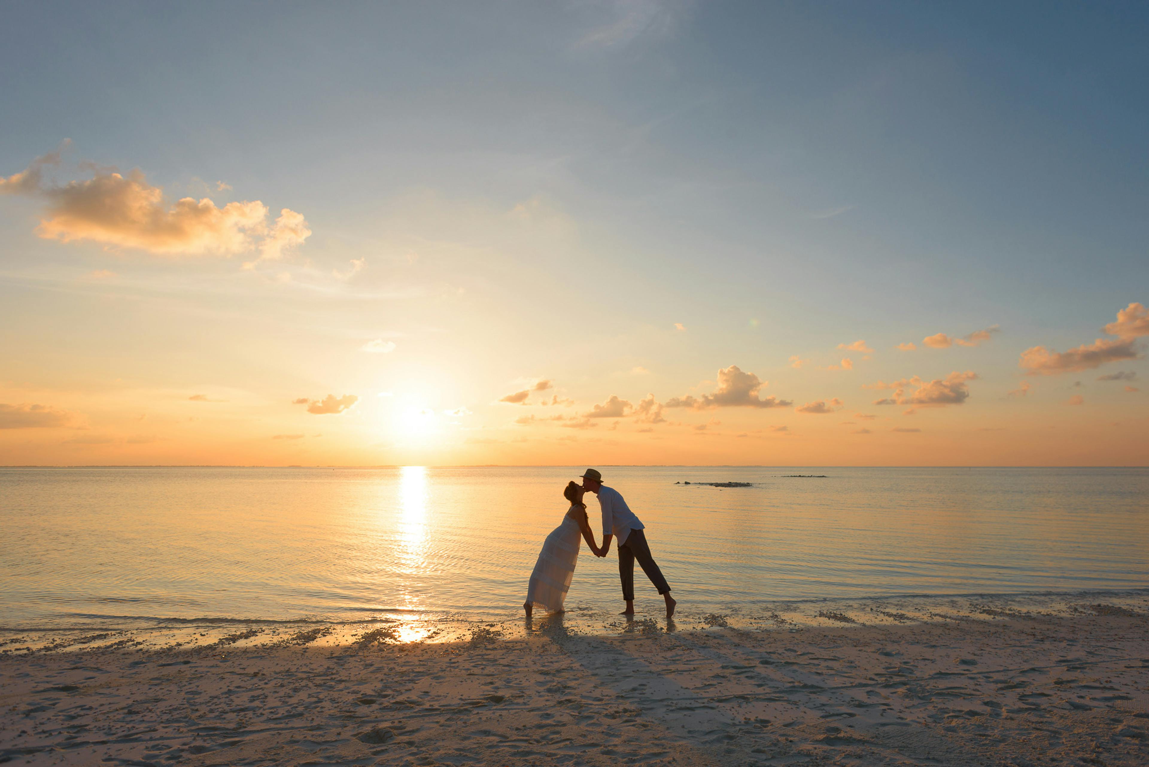 Couple enjoying sunset at Sri Lankan beach honeymoon